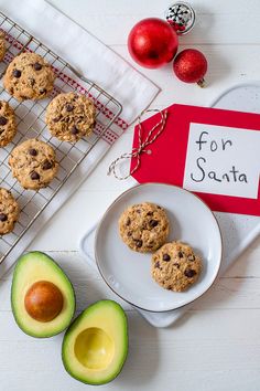 cookies and an avocado on a cooling rack next to a sign that says for santa