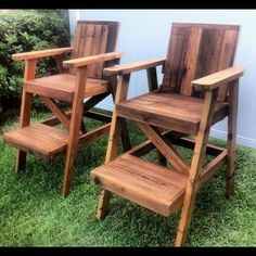 three wooden chairs sitting in the grass