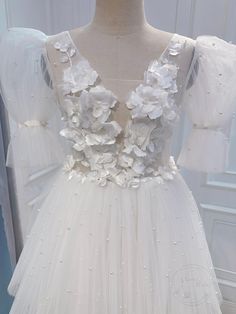 a white dress with flowers on it