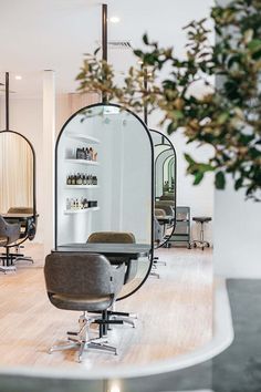 a salon with mirrors and chairs in it