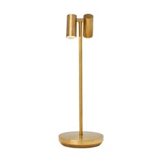 a gold colored floor lamp with two lights on each side and one light on the other