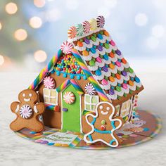 a gingerbread house with two gingers on the front and one ginger in the back