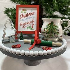 a cake with decorations on it and a christmas card in the middle, sitting on top of a table