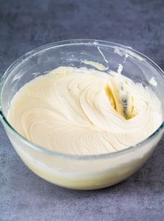 a glass bowl filled with batter on top of a table