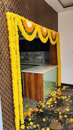 a kitchen decorated with yellow flowers and garlands