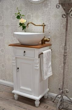 a white sink sitting on top of a wooden counter