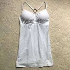 95% Cotton, 5% Spandex White Fitted Crisscross Top, Fitted White Crisscross Top, Fitted Solid Color Cross Back Top, Fitted Cross Back Top, White Fitted Cross Back Top, White Cross Back Tank Top For Summer, Fitted Strappy Top For Workout, Fitted White Cross Back Tank Top, White Fitted Cross Back Tank Top