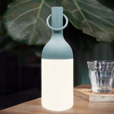 The object of conviviality with its iconic design in the shape of a bottle, designed by Bina Bartel, the ELO lamps will distill a warm atmosphere on your large tables as well as your one-to-one dinners. The removable ring located at the top of each lamp will also allow you to hang your ELO baby on the branch of a tree, a wire, or a hook to illuminate your outdoor spaces. With a powerful light intensity adjustable with the fingertip and an autonomy of up to 40 hours, the ELO lamps are a compendiu Wireless Lamp, Outdoor Table Lamp, Baby Table, Outdoor Table Lamps, Portable Table, Backyard Living, Led Table, Luminaire Design, Led Table Lamp