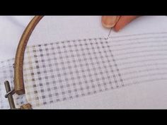 someone is stitching fabric with a sewing needle