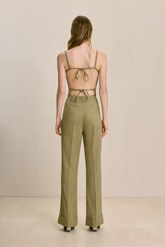 A corset-style top with boning and two back ties with adjustable straps. — Scoop neckline — Open back with functional ties — Subtle v-shaped hem — Wear with the Lindsey Pant Spring Backless Bottoms With Tie Back, Chic Strapped Bottoms For Summer, Chic Summer Bottoms With Straps, Chic Bottoms With Straps For Summer, Chic Fitted Bottoms With Adjustable Straps, Fitted Bottoms With Adjustable Straps For Spring, Chic Fitted Bottoms With Tie Back, Corset Style Tops, Cult Gaia