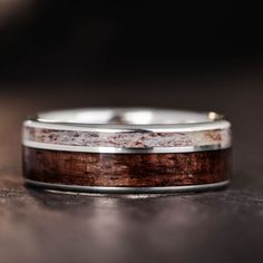 a wedding band with wood and silver inlays