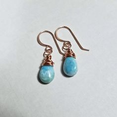 "Made to order. Current production times for made to order items can be found in the shop announcement or on the shop policies page. Gorgeous, marbled larimar gemstones dangle from tiny hoops. Perfect for just a touch of color! *The first five pictures are in gold filled, and the last two are in rose gold filled. Sterling silver photos to come in the future. ~ larimar ~ gold filled, rose gold filled, or sterling silver wire and ear wires ~ approximately 1 1/4 inches (3.2 cm), from the top of the Larimar Dangle Earrings For Gifts, Hypoallergenic Larimar Jewelry As A Gift, Hypoallergenic Larimar Jewelry For Gifts, Larimar Dangle Earrings As Gift, Aqua Gemstone, Earring Ideas, Jewelry Pouch, Stone Earrings, Silver Wire