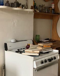 an old stove with many books on top of it