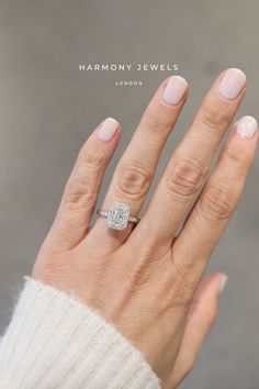 a woman's hand with a diamond ring on top of her left hand and the words harmony jewels