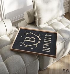 a framed sign sitting on top of a couch