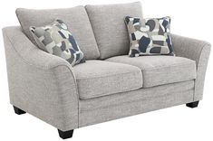 a gray couch with blue and white pillows on it's backrest, against a white background