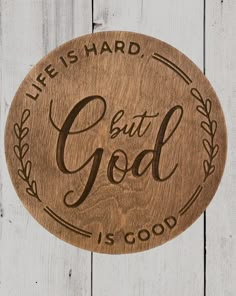 a wooden plaque with the words, life is hard but god is good on it