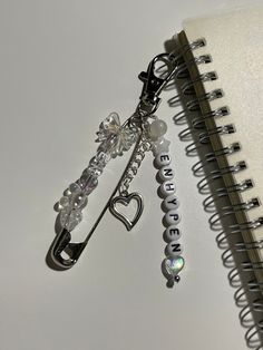 a spiral notebook with a key chain attached to it