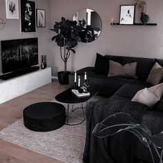 a living room filled with furniture and a flat screen tv mounted on a wall above a fireplace