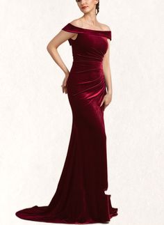 a woman in a red dress posing for the camera with her hands on her hips