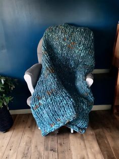 a blue blanket sitting on top of a chair