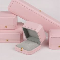 pink jewelry boxes with gold handles and lids