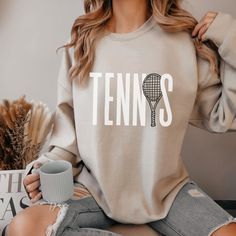 Thank you for clicking on my tennis sweatshirt listing. These tennis crewneck sweatshirts are super soft and comfy. This shirt would make an excellent gift for a tennis player or tennis coach. Choose between a pink tennis sweatshirt, blue tennis sweatshirt, grey tennis sweatshirt, or sand tennis sweatshirt. Double check the size guide before placing your order. These sweatshirts are unisex fit. If you like this listing, visit my shop. I'm a full time band teacher that sells laser items, apparel, and ornaments. teamfreitas.etsy.com/shop Tennis Sweatshirt Tennis Gift for Women Tennis Shirt Tennis Player Gift Tennis Coach Gift Tennis Mom Tennis Apparel Tennis Lover Gifts Tennis Spirit Wear, Tennis Graphic Print Sweatshirt For Sports Season, Tennis Graphic Print Sweatshirt, Long Sleeve Graphic Sweatshirt For Tennis, Long Sleeve Graphic Print Sweatshirt For Tennis, Graphic Print Long Sleeve Sweatshirt For Tennis, Graphic Print Long Sleeve Tennis Sweatshirt, Cotton Crew Neck Sweatshirt For Tennis, Cotton Crew Neck Tennis Sweatshirt