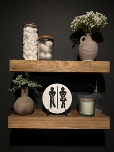 two wooden shelves with vases and jars on them