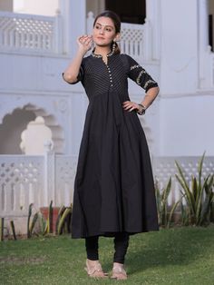 Black Cotton Anarkali with zari embroidery on front yoke, collar & sleeves along with potli buttons detailing, flared hemline, side pockets, solid churidar with drawstring closure and black printed dupatta. SPECIFICATION: Colour - Black Top Shape - Anarkali Kurta Top Pattern - Zari Embroidery Collar with Potli button details & side pocket. Sleeves - 3/4 Sleeves Bottom Type - Solid Churidar With Drawstring closure. Dupatta Print - Printed FABRIC : Top Fabric - Cotton Bottom Fabric - Cotton Dupatt Gold Anarkali, Potli Button, Chanderi Suit, Embroidery Collar, Kurta Top, Cotton Anarkali, Chanderi Suits, Zari Embroidery, Printed Dupatta