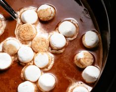 marshmallows are being cooked in the crock pot with chocolate and sauce