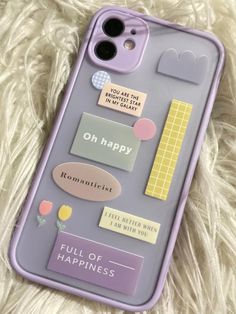 an iphone case with some stickers on it