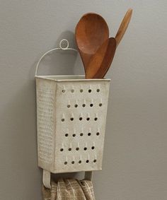 a kitchen utensil holder holding wooden spoons and spatulas