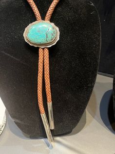 Beautiful turquoise stone on sterling silver with brown woven leather and hand made silver tips. Hand Tooled Luxury Formal Jewelry, Luxury Hand Tooled Jewelry For Formal Occasions, Adjustable Elegant Jewelry With Patina Detail, Elegant Adjustable Jewelry With Patina, Formal Brown Concho Jewelry, Southwestern Silver Leather Jewelry, Artisan Turquoise Jewelry For Formal Occasions, Elegant Hand-tooled Brown Jewelry, Elegant Hand Tooled Brown Jewelry