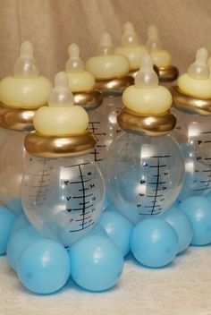 there are many glass jars with musical notes on them and blue balloons in the foreground