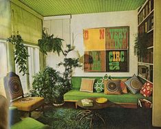 a living room filled with lots of green furniture and plants on top of the walls