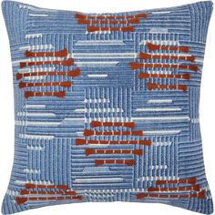 a blue pillow with red and white designs on it