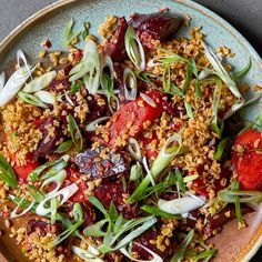 a plate full of food that includes carrots, onions and sprouts on it