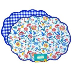 a blue and white checkered tray with flowers on the bottom, in front of a gingham background