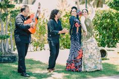 a group of people that are standing in the grass