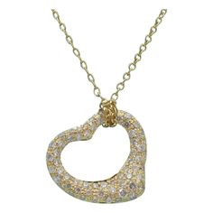 TIFFANY & Co. Elsa Peretti 18K Gold .40ct Diamond Open Heart Pendant Necklace Metal: 18K Yellow Gold Chain: 16" long Pendant: 16mm wide Diamond: carat total weight .40ct Hallmark: "TIFFANY&Co. ©Elsa Peretti AU750 SPAIN" on pendant, "TIFFANY&CO. 750 Elsa Peretti SPAIN" on chain tags Condition: Excellent condition, like new, comes with Tiffany box Tiffany price: $8,600 Authenticity Guaranteed Heart Diamond Necklace, Open Heart Ring, Tiffany Box, Open Heart Necklace, Heart Necklace Diamond, Gold Long Necklace, Elsa Peretti, Versatile Jewelry, Heart Diamond