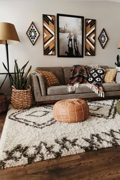 a living room filled with lots of furniture and pictures on the wall above it's couch