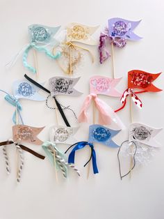 several different colored hair bows on sticks