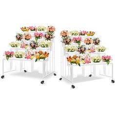 two white chairs with flowers on them sitting side by side in front of each other