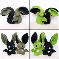 four different images of stuffed animals with hearts on their ears and eyes, one in the shape of a bat