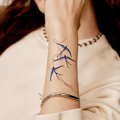 a woman with a tattoo on her wrist