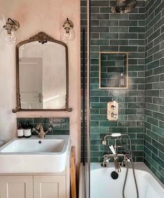 a bath room with a sink and a bath tub next to a mirror on the wall