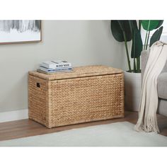 a wicker storage box with books on top