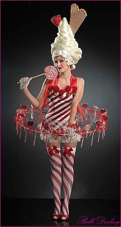 a woman dressed in candy and holding a lollipop