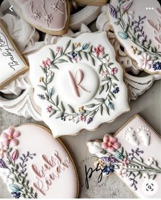 cookies decorated with flowers and leaves are on display for someone to write their names in