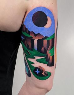 a person with a tattoo on their arm that has mountains and stars in the sky